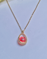 Gold Plated Minimalist Pendent, close up of red preserved flower in resin